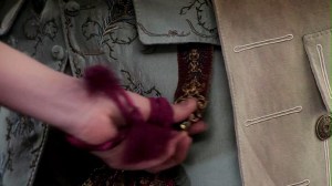 Geillis Duncan grabs Lord John Grey's sapphire fob.